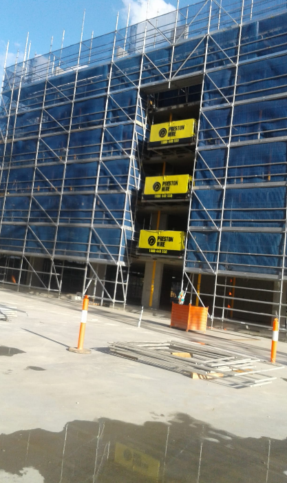 Scaffolding with green safety netting on a construction project